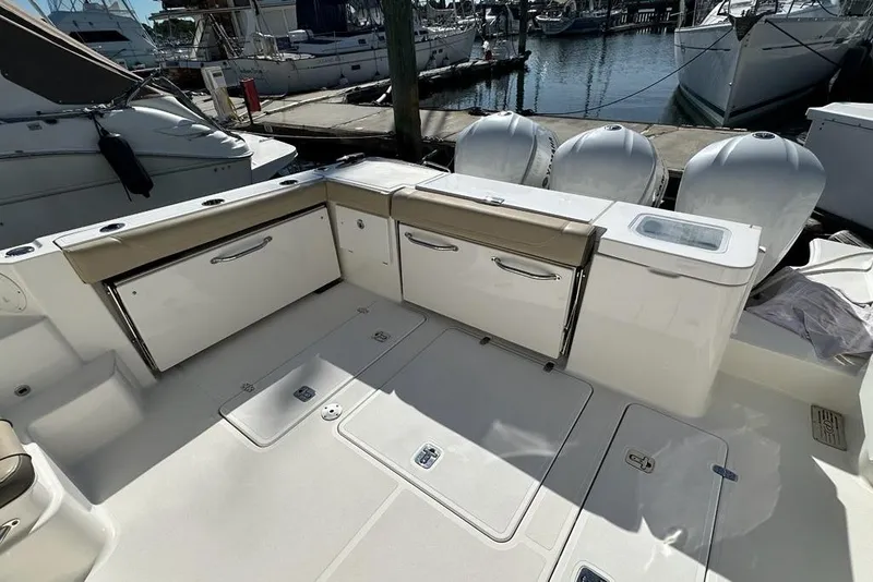 Slide: The Image of 2020 Pursuit OS 355 Offshore boat deck with storage compartments and outboard motors. - 30