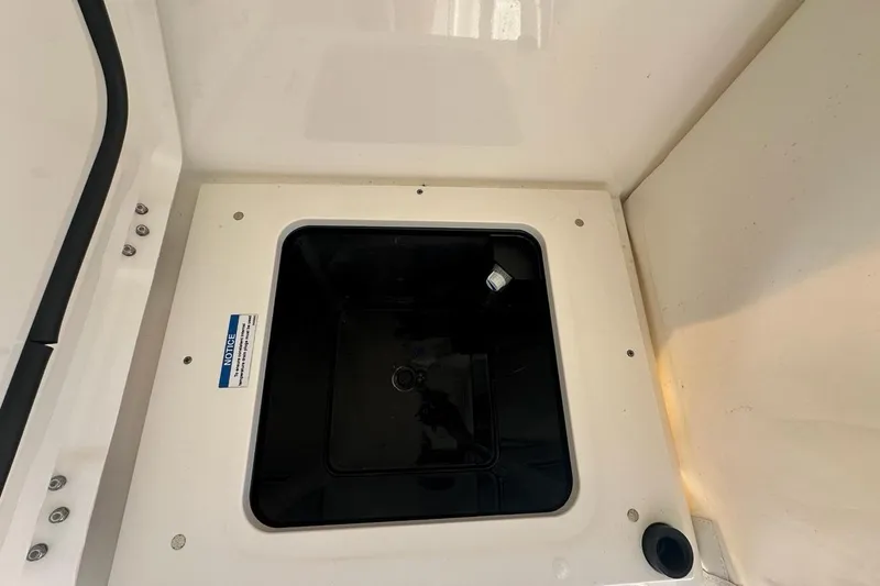 Slide: The Image of 2020 Pursuit OS 355 Offshore boat compartment with black interior and white exterior. - 35