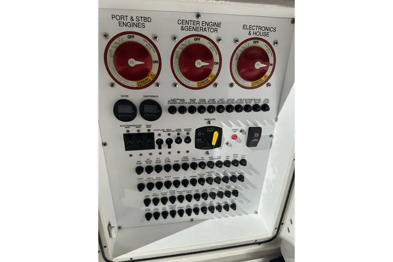 Slide: The Image of Control panel of a 2020 Pursuit OS 355 Offshore boat with engine switches. - 36