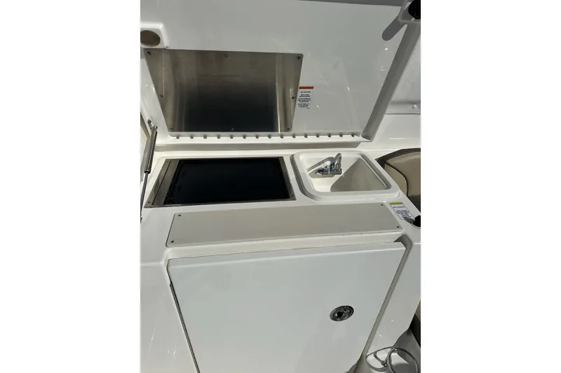 Slide: The Image of 2020 Pursuit OS 355 Offshore boat galley with sink and storage compartments. - 39