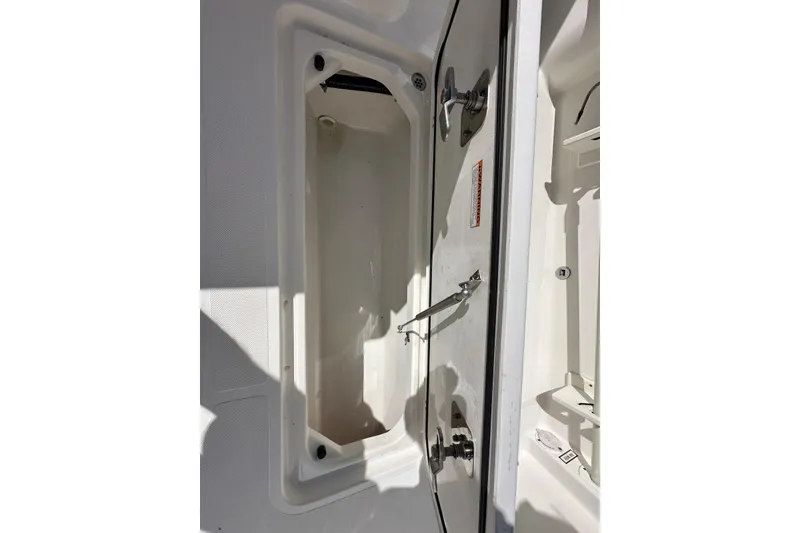 Slide: The Image of 2020 Pursuit OS 355 Offshore boat storage compartment, open and empty. - 43