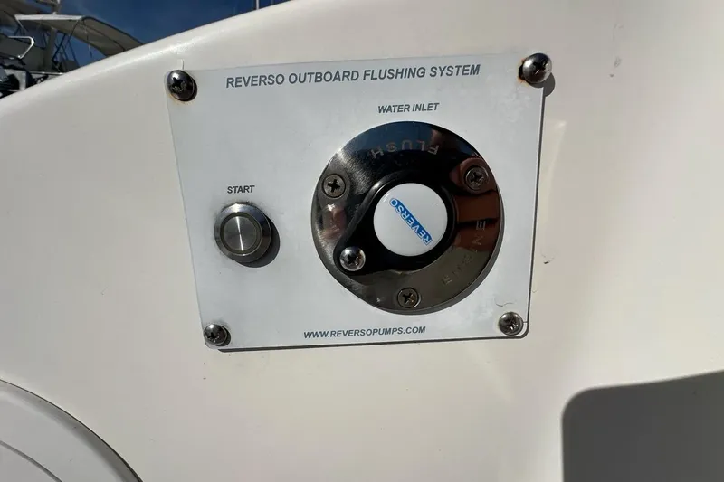 Slide: The Image of Reverso outboard flushing system on 2020 Pursuit OS 355 Offshore boat. - 44