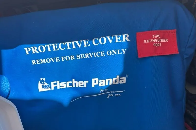 Slide: The Image of Blue protective cover with Fischer Panda logo and fire extinguisher port label. - 50
