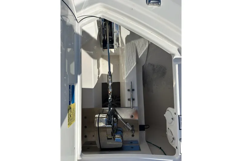 Slide: The Image of 2020 Pursuit OS 355 Offshore anchor compartment with winch and chain mechanism. - 53