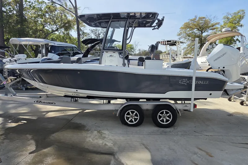 Slide: The Image of 2021 Crevalle 24 HCO boat on trailer, parked outdoors. - 13