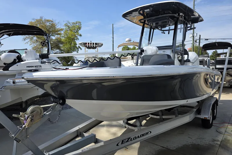 Slide: The Image of 2021 Crevalle 24 HCO boat on trailer with Minn Kota motor, parked outdoors. - 15