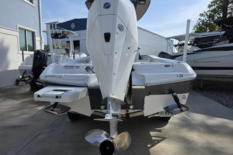 Slide: The Image of 2021 Crevalle 24 HCO boat with outboard motor, parked outdoors. - 16