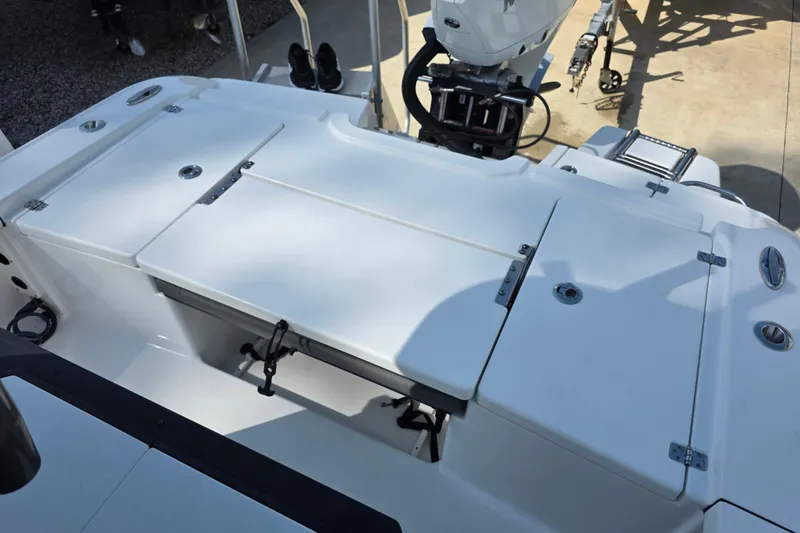 Slide: The Image of 2021 Crevalle 24 HCO boat deck with storage compartments and motor. - 17