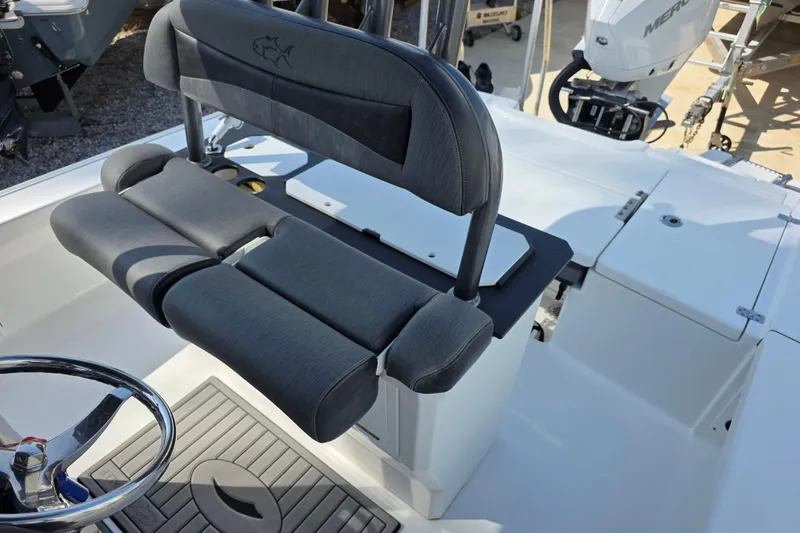 Slide: The Image of 2021 Crevalle 24 HCO boat interior with cushioned seating and steering wheel. - 20