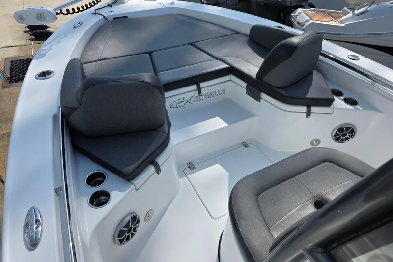 Slide: The Image of 2021 Crevalle 24 HCO boat interior with cushioned seating and cup holders. - 21