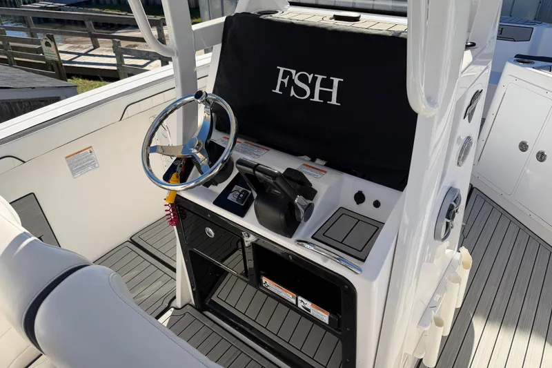 Slide: The Image of 2022 Yamaha Boats 252 FSH Sport helm with steering wheel and controls. - 20