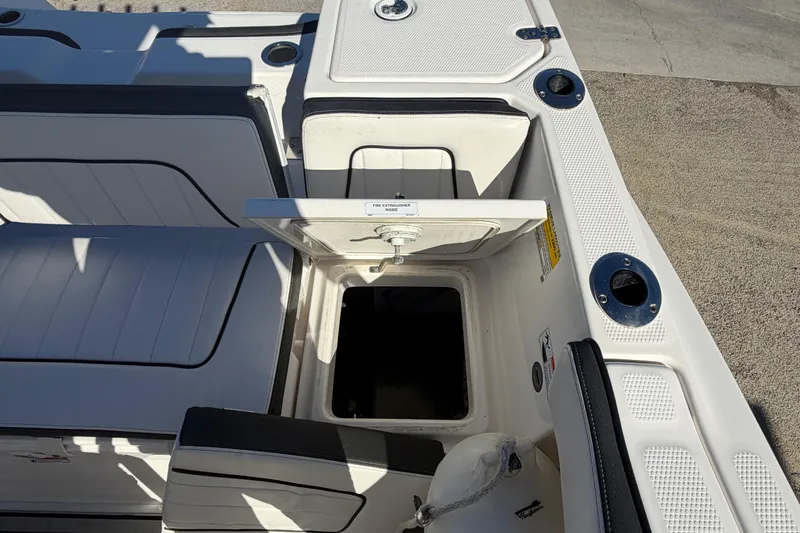 Slide: The Image of 2022 Yamaha Boats 252 FSH Sport open storage compartment on deck. - 26