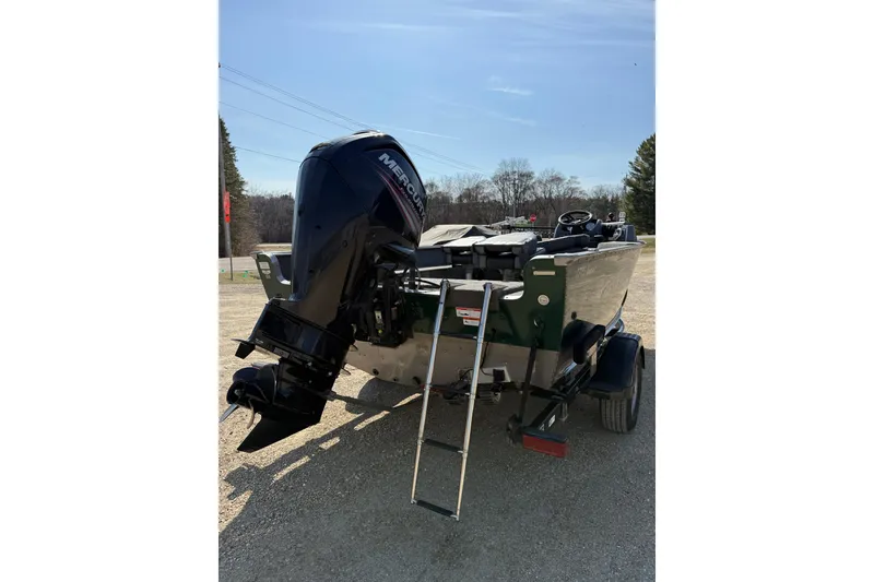 Slide: The Image of 2017 Lund 1775 Impact SS boat with Mercury outboard motor and ladder on trailer. - 14