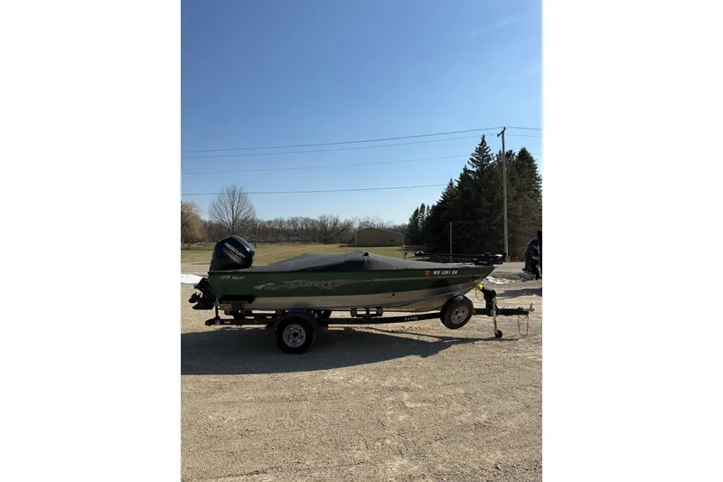 Slide: The Image of 2017 Lund 1775 Impact SS fishing boat on trailer, parked outdoors. - 15