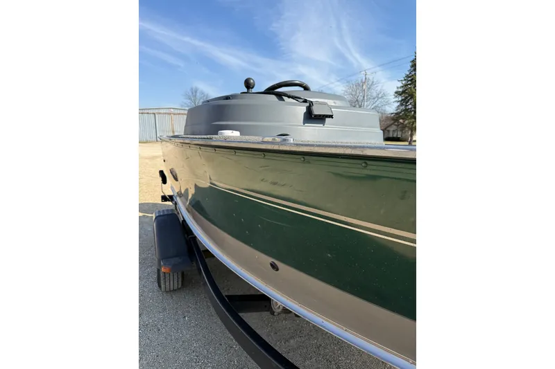 Slide: The Image of 2017 Lund 1775 Impact SS boat on trailer under clear blue sky. - 17