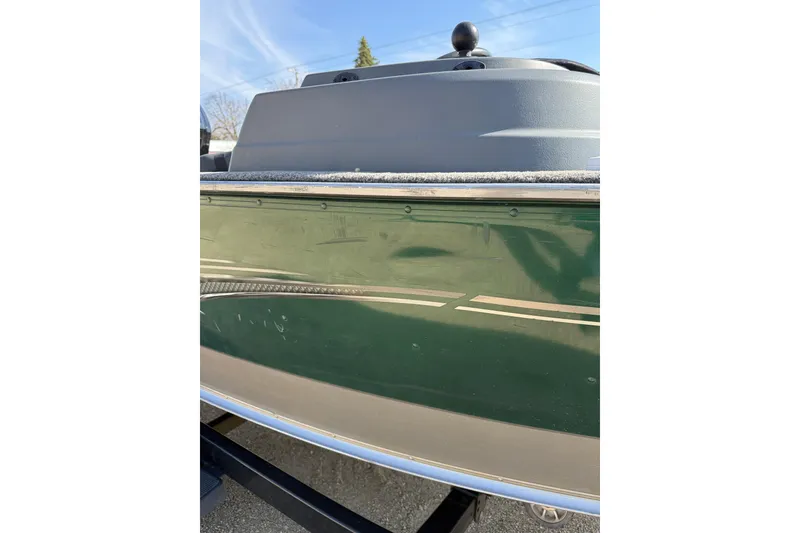 Slide: The Image of 2017 Lund 1775 Impact SS boat side view with green exterior and sleek design. - 19