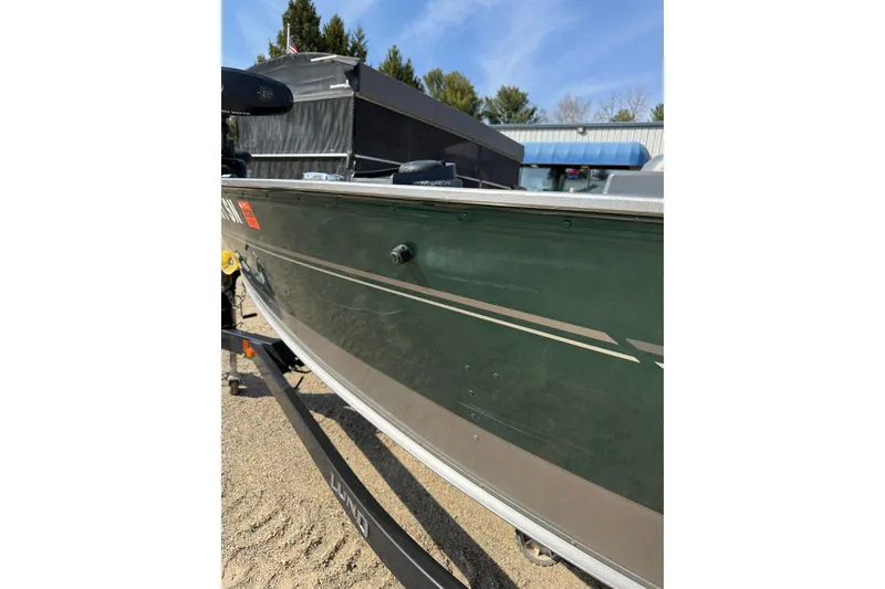 Slide: The Image of 2017 Lund 1775 Impact SS boat on trailer, side view with green exterior. - 23