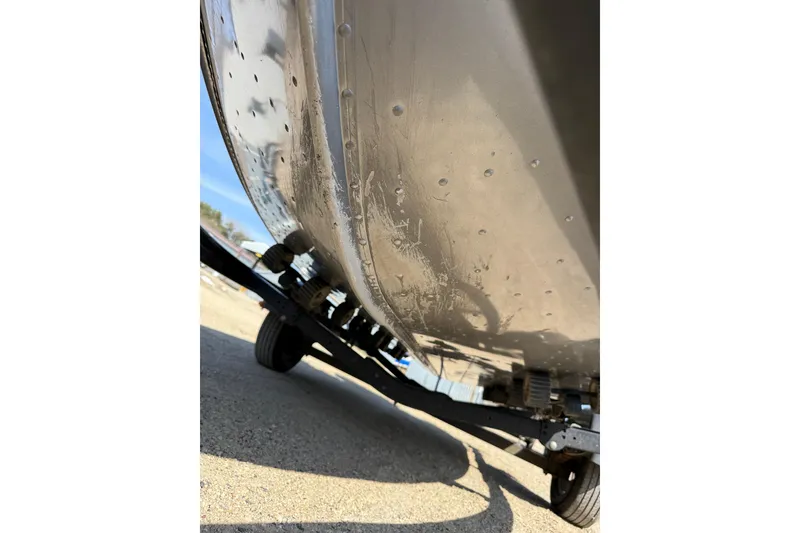 Slide: The Image of 2017 Lund 1775 Impact SS boat hull on trailer, showing underside details. - 24