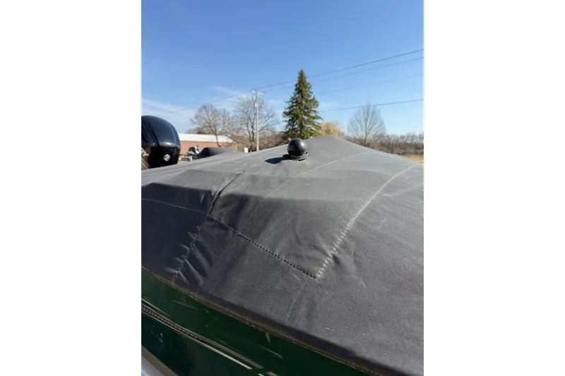 Slide: The Image of 2017 Lund 1775 Impact SS boat with protective cover under clear blue sky. - 26