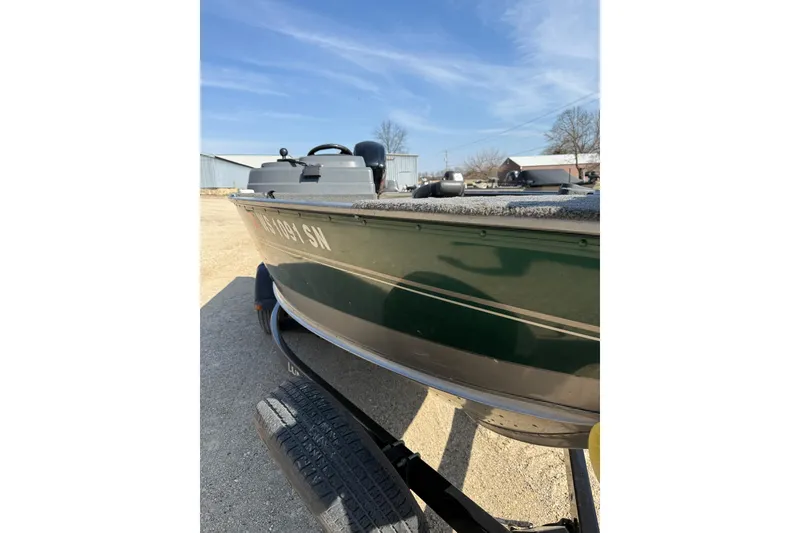 Slide: The Image of 2017 Lund 1775 Impact SS boat on trailer, parked outdoors under clear sky. - 27