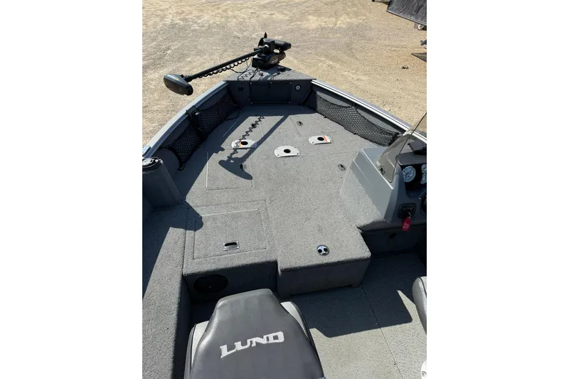 Slide: The Image of 2017 Lund 1775 Impact SS boat interior with carpeted deck and seating. - 3