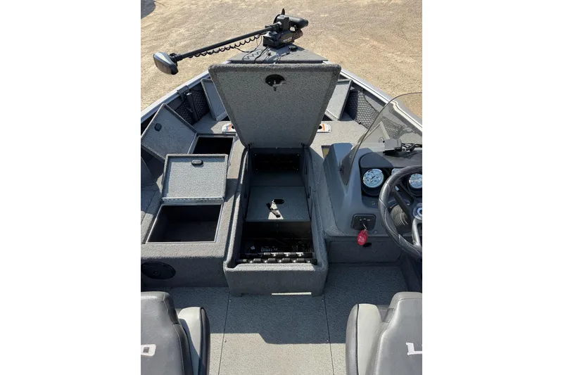Slide: The Image of 2017 Lund 1775 Impact SS boat interior with open storage compartments and control panel. - 5