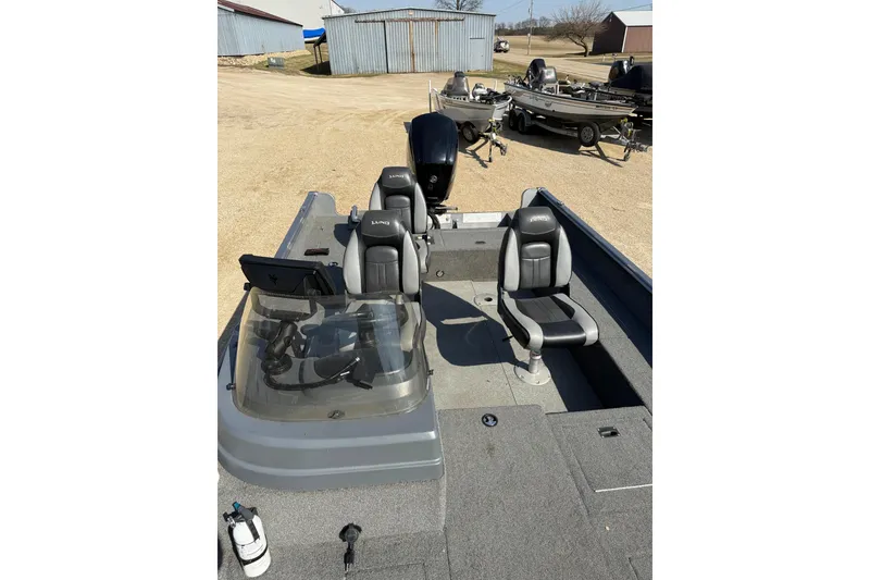 Slide: The Image of 2017 Lund 1775 Impact SS fishing boat with dual seats and windshield, parked outdoors. - 8