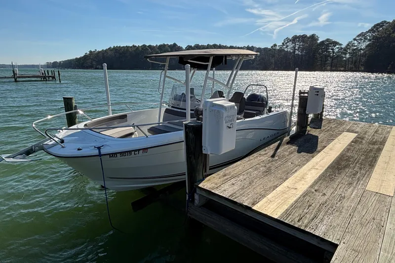 The Image of 2023 Jeanneau Leader 6.5 CC Series 3 boat docked on a sunny lake. - 0