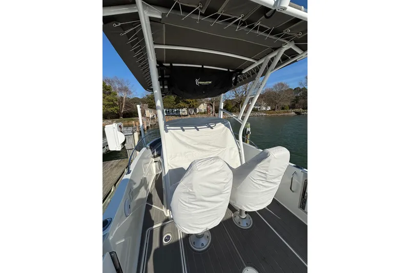 Slide: The Image of 2023 Jeanneau Leader 6.5 CC Series 3 boat interior with covered seats and canopy. - 11