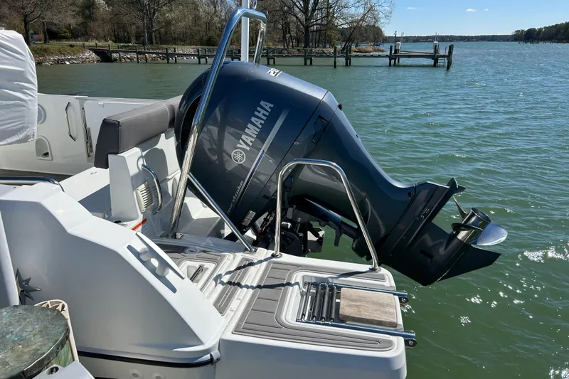 Slide: The Image of 2023 Jeanneau Leader 6.5 CC Series 3 with Yamaha outboard motor on a lake. - 12