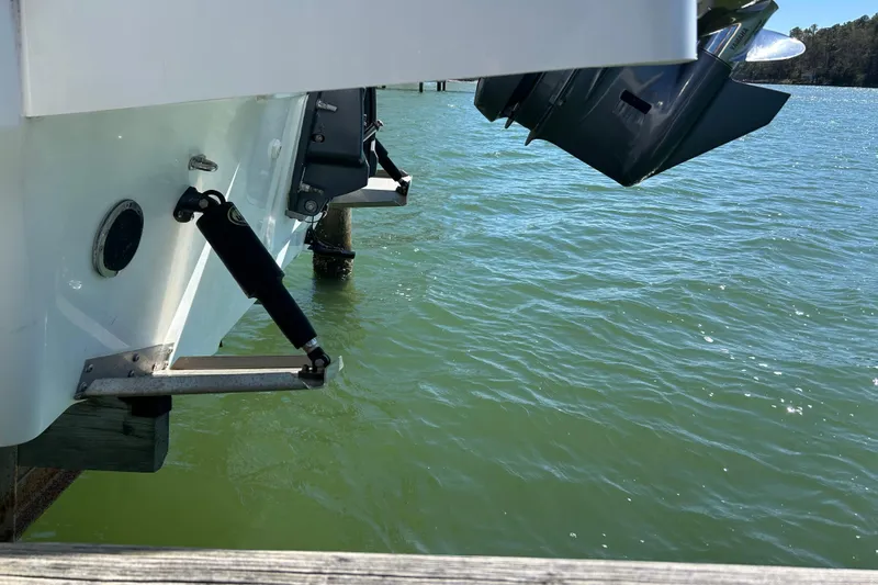 Slide: The Image of 2023 Jeanneau Leader 6.5 CC Series 3 boat stern with outboard motor on water. - 13