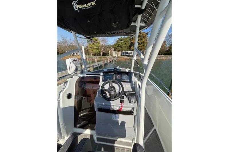 Slide: The Image of 2023 Jeanneau Leader 6.5 CC Series 3 boat interior with steering wheel and controls. - 4