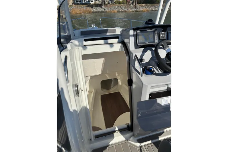Slide: The Image of 2023 Jeanneau Leader 6.5 CC Series 3 boat interior with helm and cabin entrance. - 5