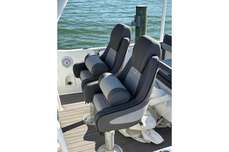 Slide: The Image of 2023 Jeanneau Leader 6.5 CC Series 3 boat seats, overlooking water. - 6
