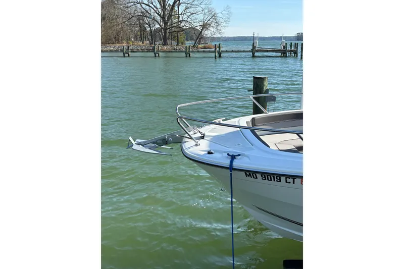 Slide: The Image of 2023 Jeanneau Leader 6.5 CC Series 3 boat docked on calm water. - 8