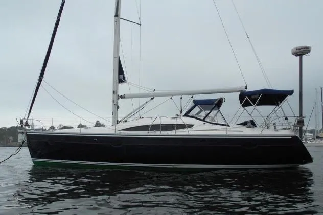 The Image of 2007 Elan Impression 434 sailboat on calm water, featuring sleek design and blue canopy. - 0