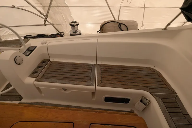 Slide: The Image of 2007 Elan Impression 434 yacht cockpit with wooden seating and steering wheel. - 11