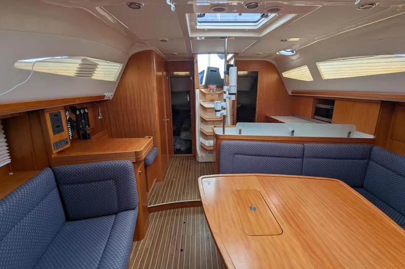 Slide: The Image of Interior of a 2007 Elan Impression 434 yacht with wooden furnishings and blue seating. - 16