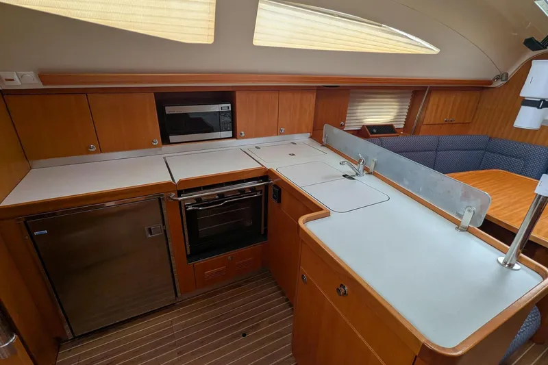 Slide: The Image of Interior of 2007 Elan Impression 434 yacht kitchen with modern appliances and wood finish. - 18