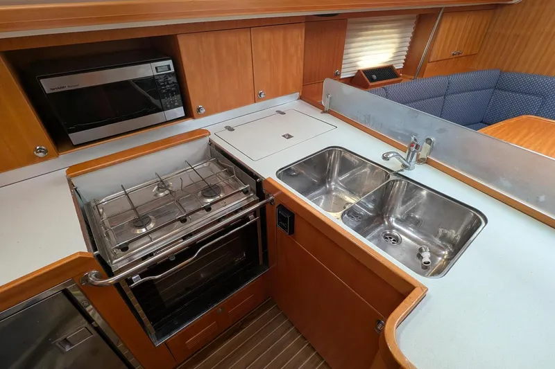 Slide: The Image of 2007 Elan Impression 434 yacht kitchen with stove, microwave, and double sink. - 19