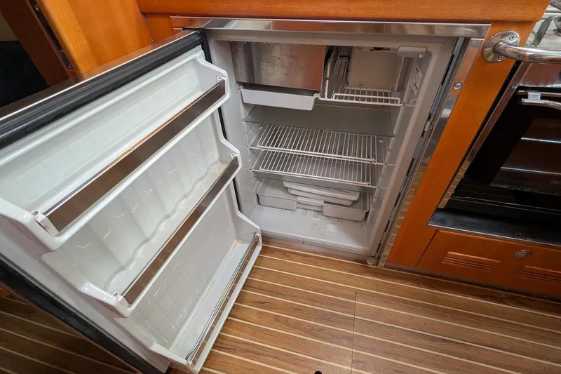Slide: The Image of Open refrigerator in 2007 Elan Impression 434 yacht kitchen, showcasing wooden interior design. - 20
