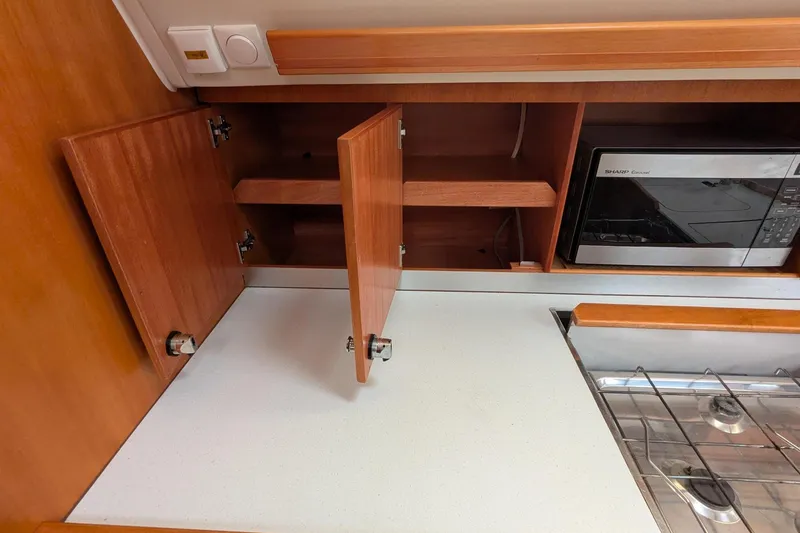 Slide: The Image of Wooden kitchen cabinets and microwave in 2007 Elan Impression 434 yacht galley. - 22