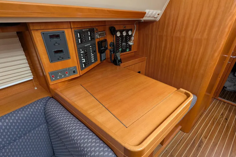 Slide: The Image of Navigation station on 2007 Elan Impression 434 yacht with control panels and wooden finish. - 23