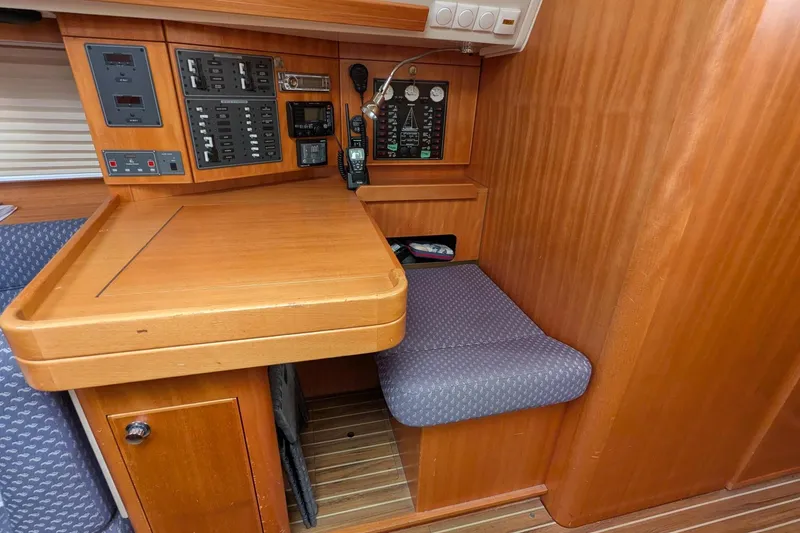Slide: The Image of Navigation station of 2007 Elan Impression 434 yacht with control panels and seating. - 24