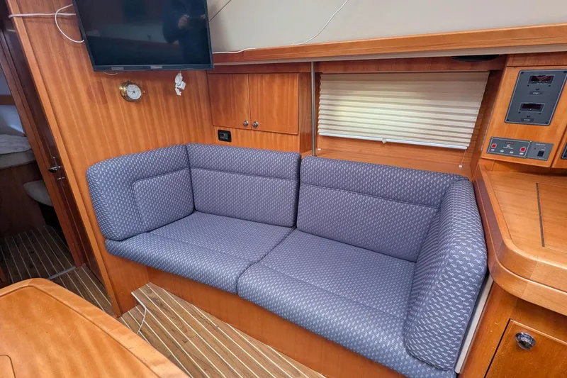Slide: The Image of Cozy interior of 2007 Elan Impression 434 yacht with blue sofa and wooden accents. - 26