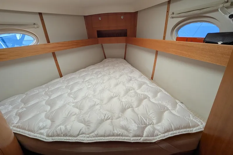 Slide: The Image of Cozy cabin bed in 2007 Elan Impression 434 yacht with porthole windows. - 31