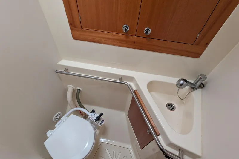 Slide: The Image of Compact bathroom in 2007 Elan Impression 434 yacht with sink and toilet. - 32