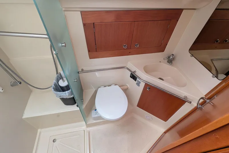 Slide: The Image of Bathroom interior of 2007 Elan Impression 434 yacht, featuring toilet, sink, and shower area. - 33