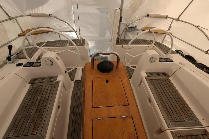 Slide: The Image of 2007 Elan Impression 434 yacht cockpit with dual steering wheels and wooden seating. - 5