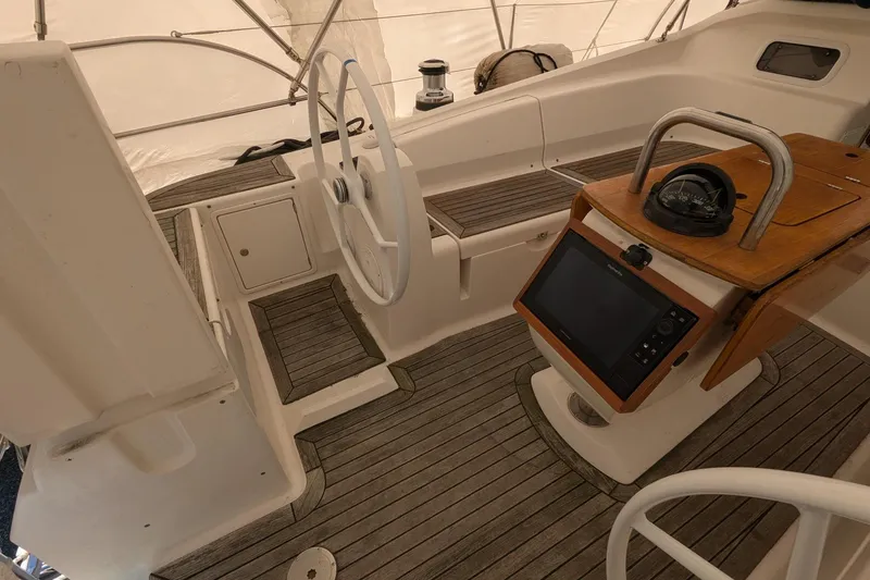 Slide: The Image of 2007 Elan Impression 434 yacht cockpit with steering wheel, navigation equipment, and wooden flooring. - 6